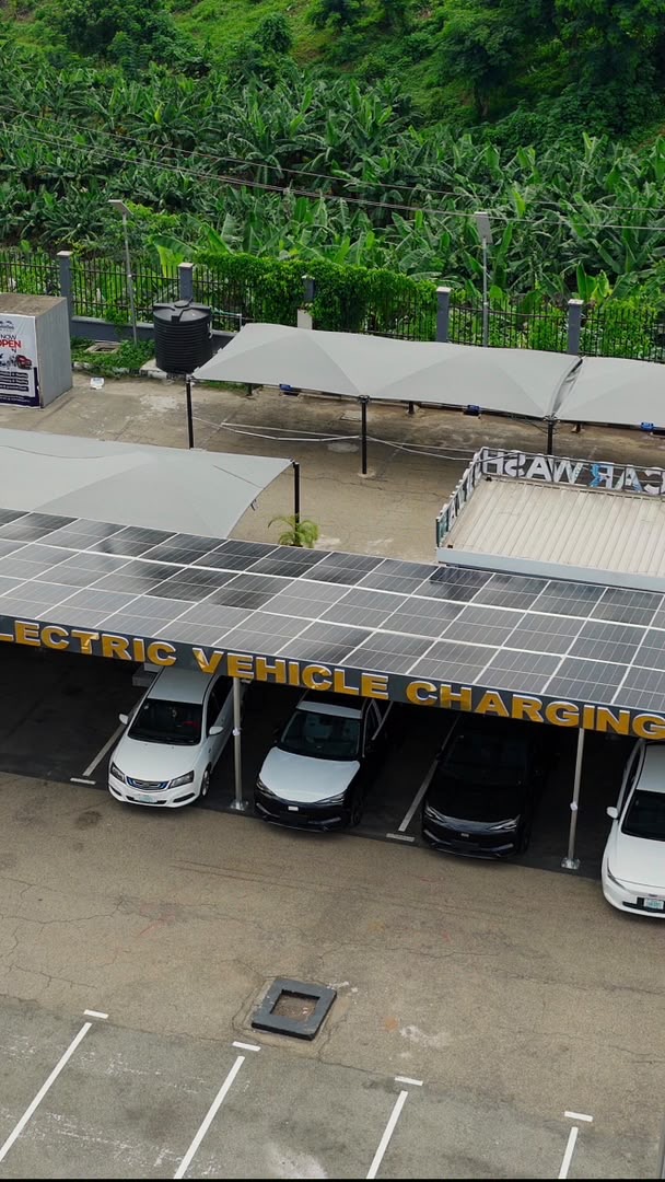Electric vehicles parked beneath a solar-panel canopy at an EV charging station