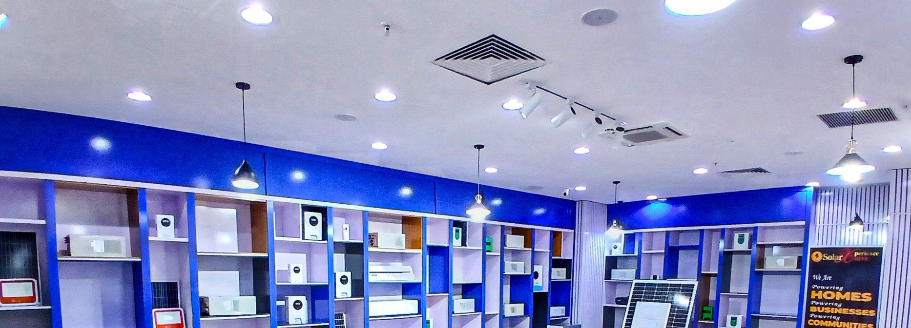 Solar World Electric showroom displaying hybrid inverters, lithium batteries and solar panels